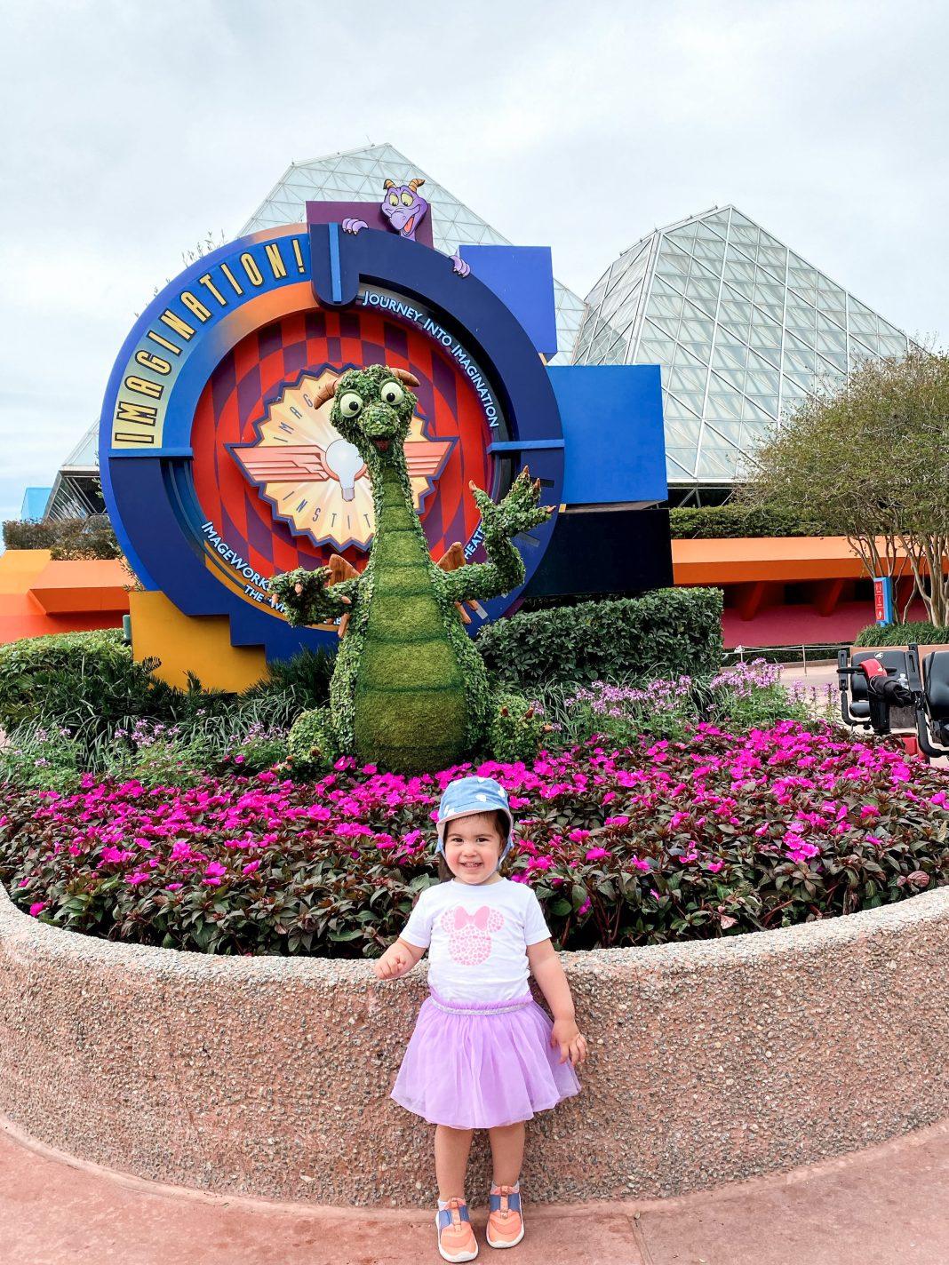 Toddler standing in front of Journey Into Imagination with Figment ride.