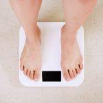 Photo of two feet standing on a white scale