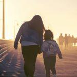 single mom walking with daughter