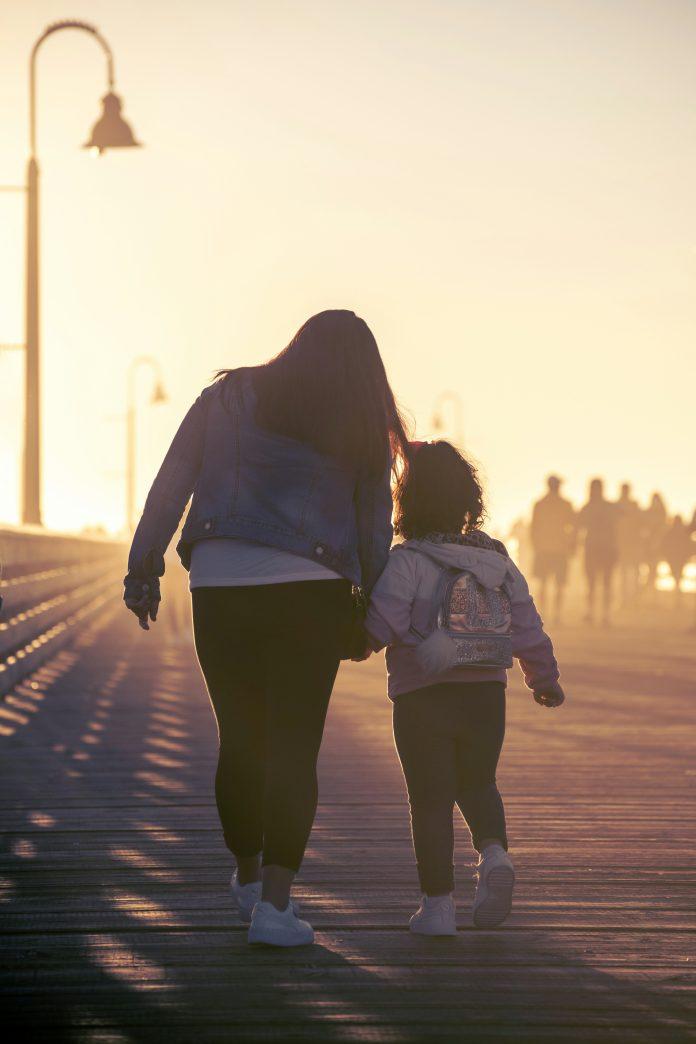 single mom walking with daughter