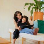 Raising bilingual kids | Latina mom reading to daughter