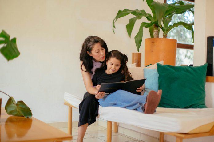 Raising bilingual kids | Latina mom reading to daughter