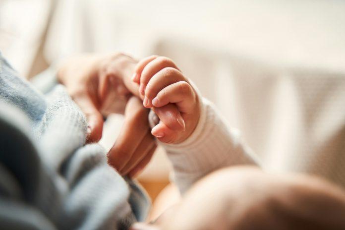 watching your kids grow up Mom Holding babies hand| The Bittersweet Truth About Watching Your Kids Grow Up
