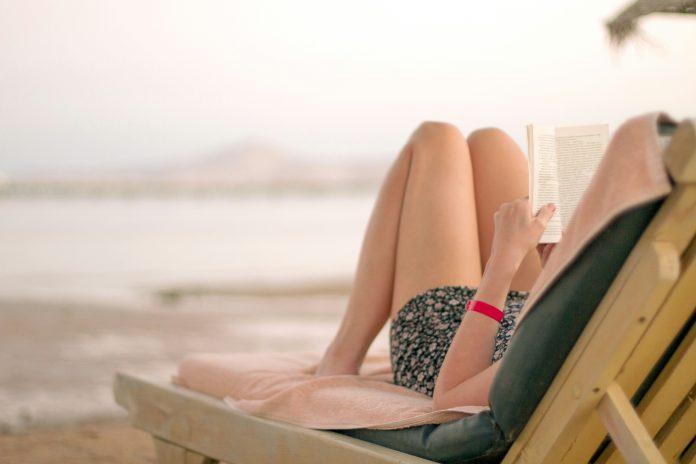 kostiantyn-li-ziV7PLz1brA-unsplash Woman on Beach Lounger Reading a Book | Gabriel García Márquez Literature Gem