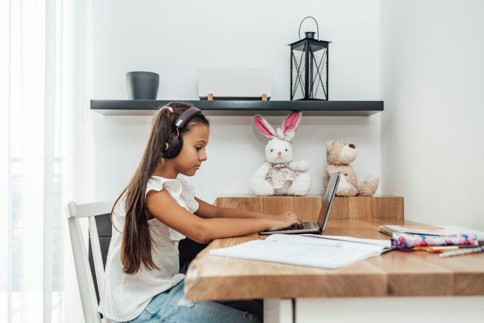 Girl Typing On Computer For Digital Learning | TruFluency Kids Spanish x Latina Mom Collective