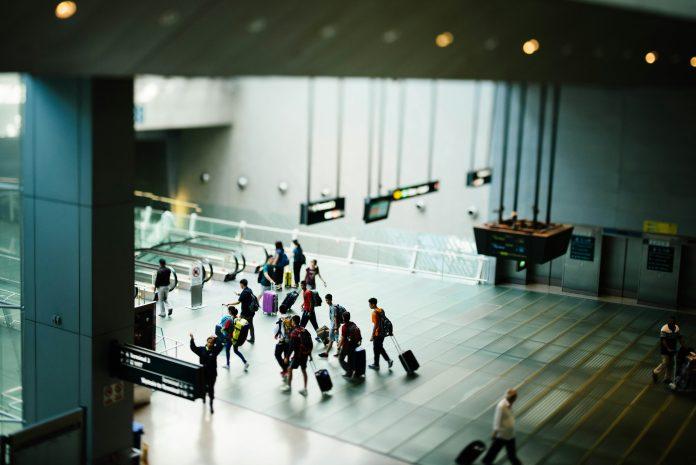 people in airport terminal | traveling alone with kids blog
