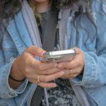 Teenager scrolling on phone | Parenting a Teenager: Walking the Tightrope Between Freedom and Safety