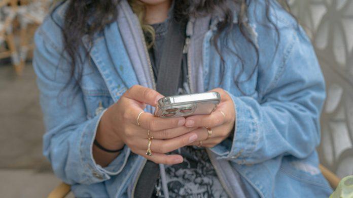 Teenager scrolling on phone | Parenting a Teenager: Walking the Tightrope Between Freedom and Safety