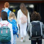 Kids walking into school with backpacks | Back to School Traditions | Latina Mom Collective