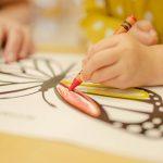 little girl coloring a butterfly coloring sheet | first day of preschool mom