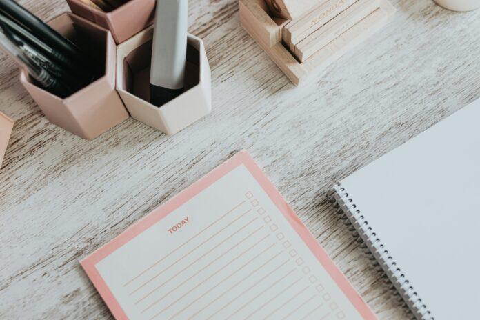 New Year Goals Desk view with a planner, writing utensils and notebook | New Year Goals