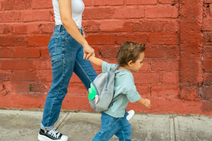 Mom and Son Walking Along Brick Wall | Between Protecting Them and Letting Them Fall | Motherhood